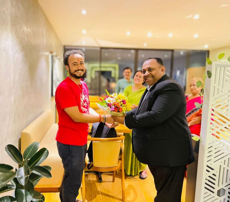 A guest receiving a bouquet in an airport lounge