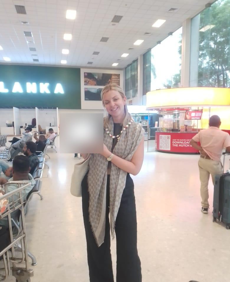 A guest smiling with her welcome tablet in the arrivals hall