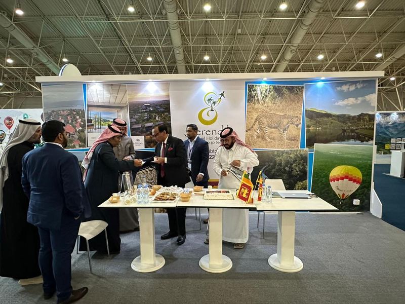 Visitors talking at the Serendib Travel Holidays stand