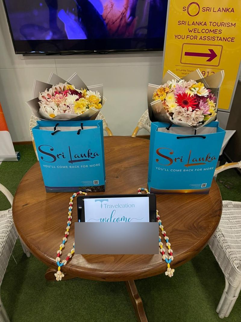 Bouquets, gift bags and garlands set out on a table at the airport